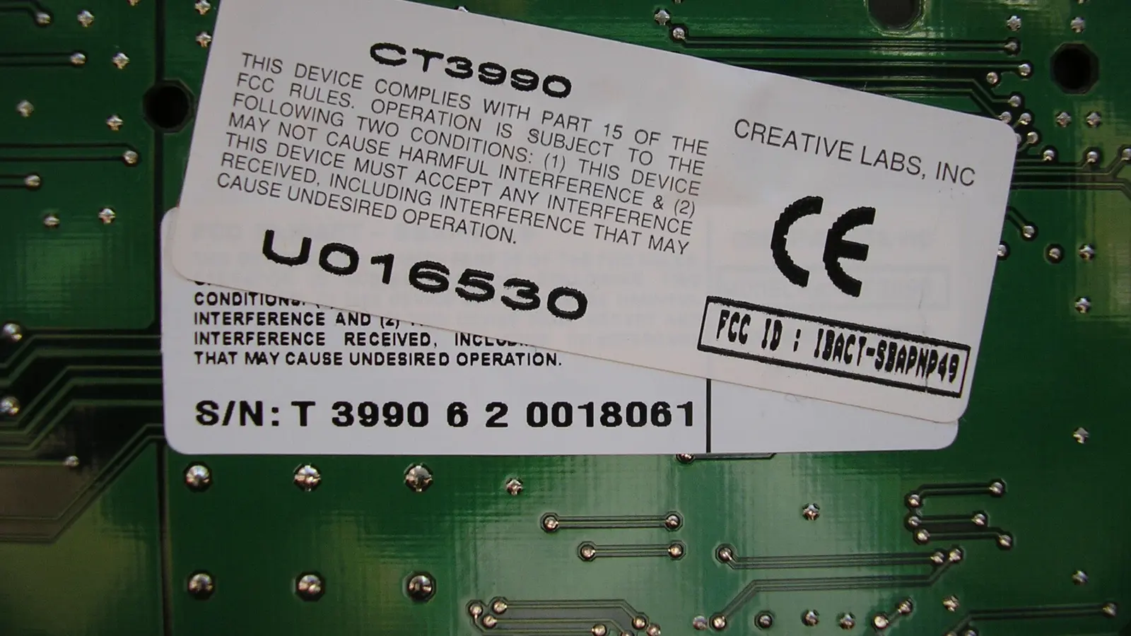 Certification label on a circuit board with CE mark, FCC ID and model CT3990