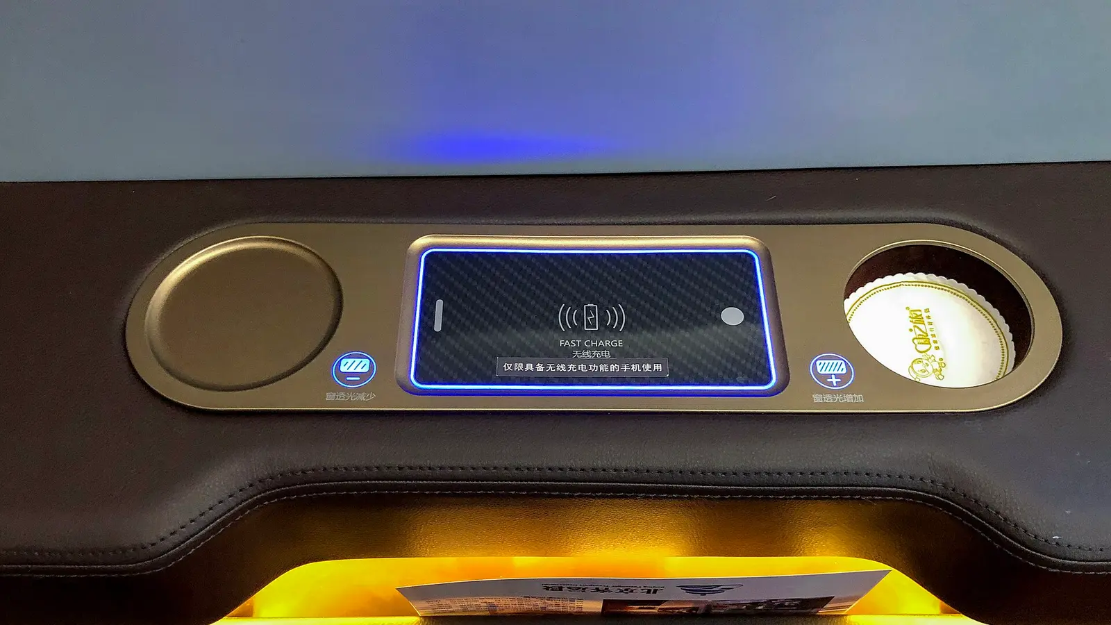 Wireless charging pad with blue light and fast charge label in a console