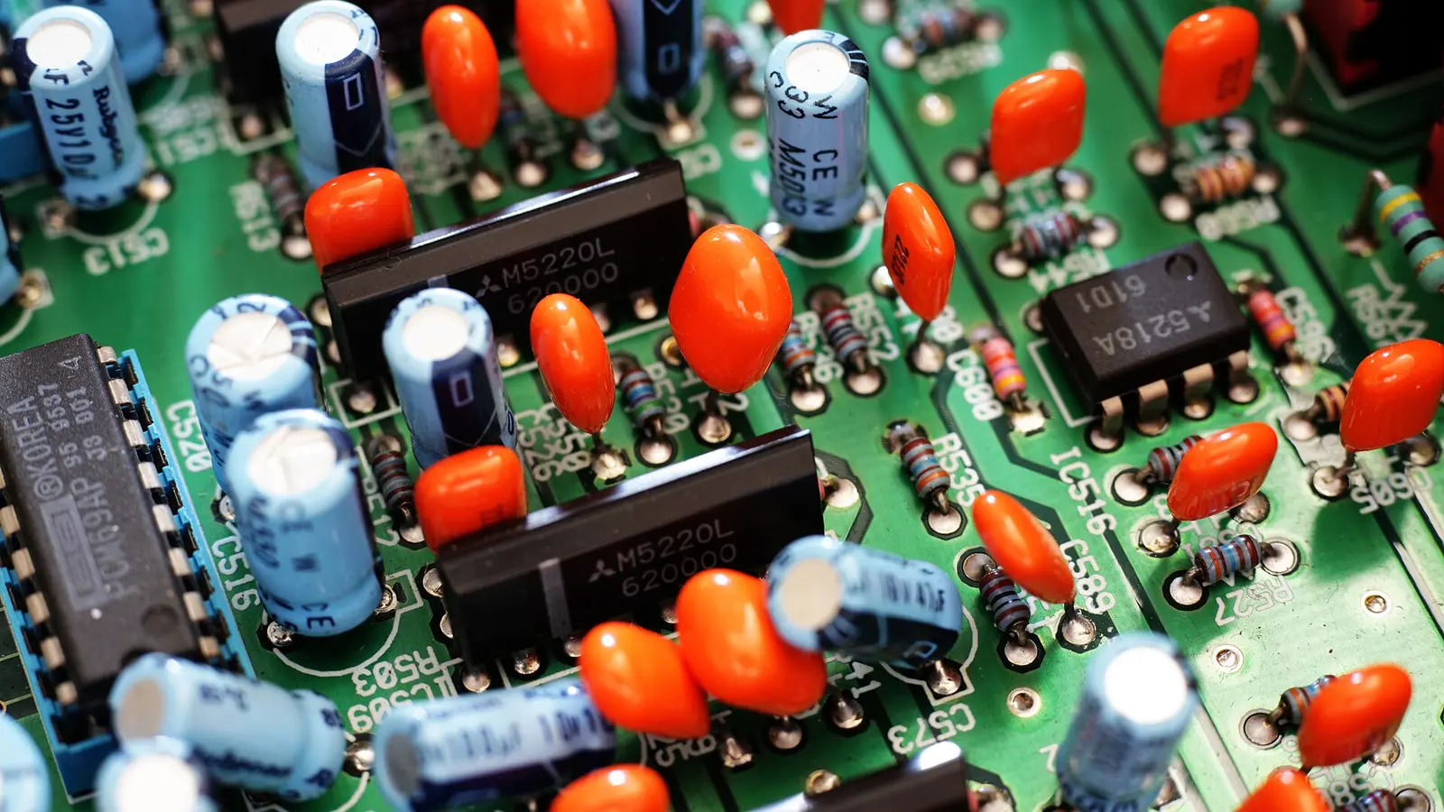 Close-up of a printed circuit board with capacitors, resistors and integrated circuits